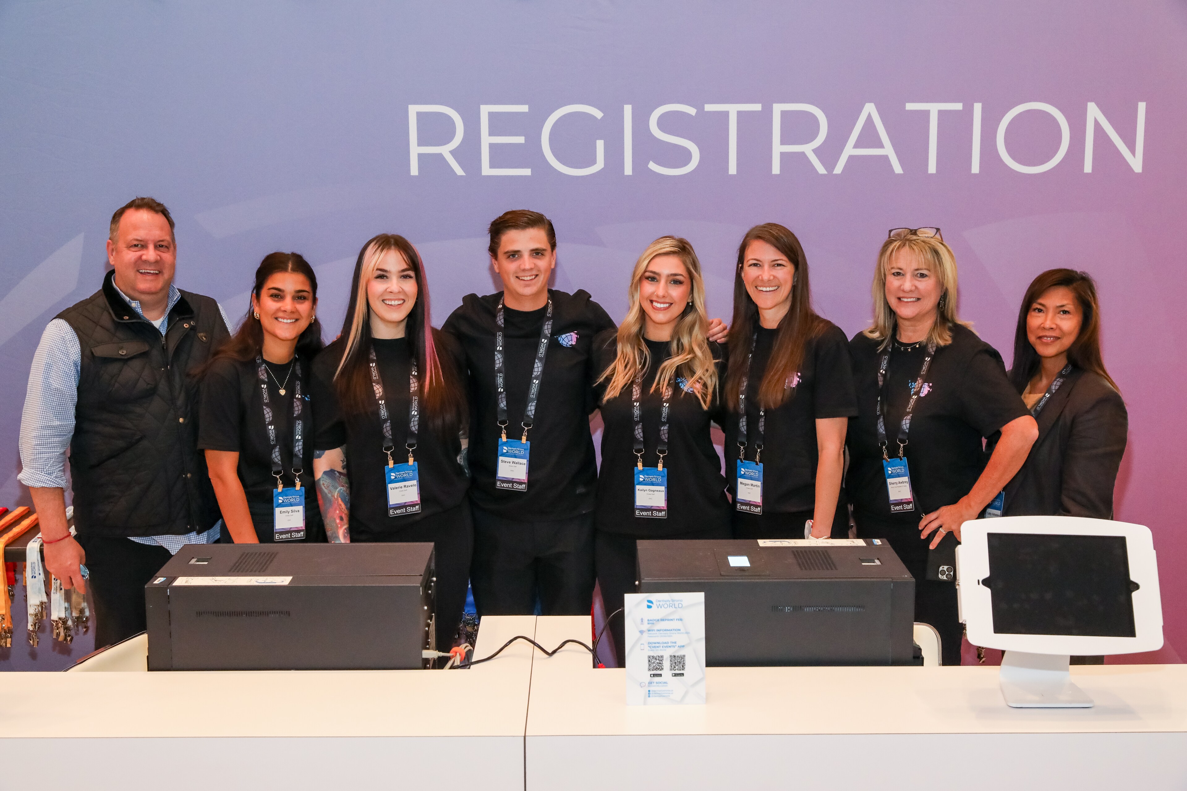 A group of people standing in front of a table