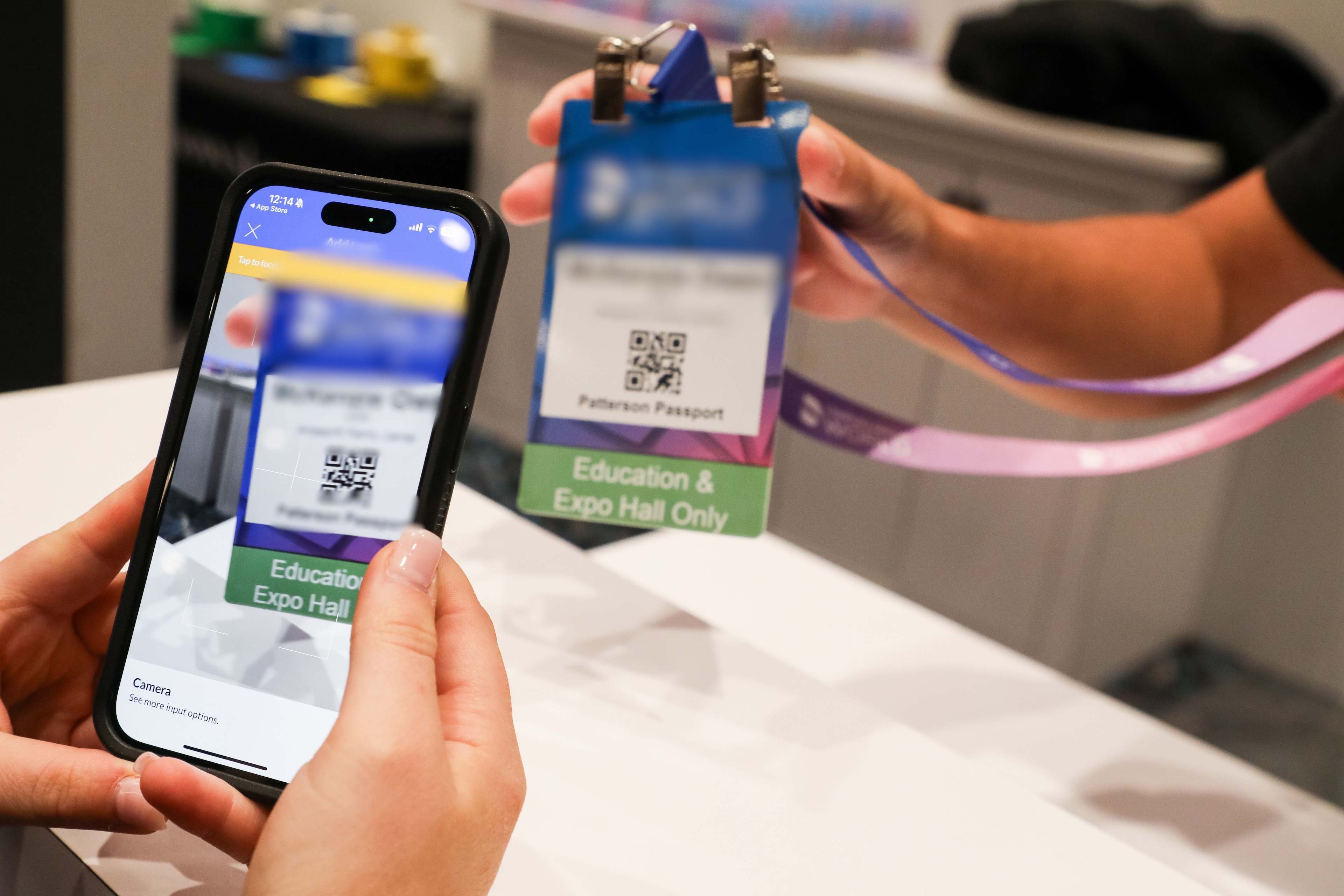 A person holding a phone and a identification card