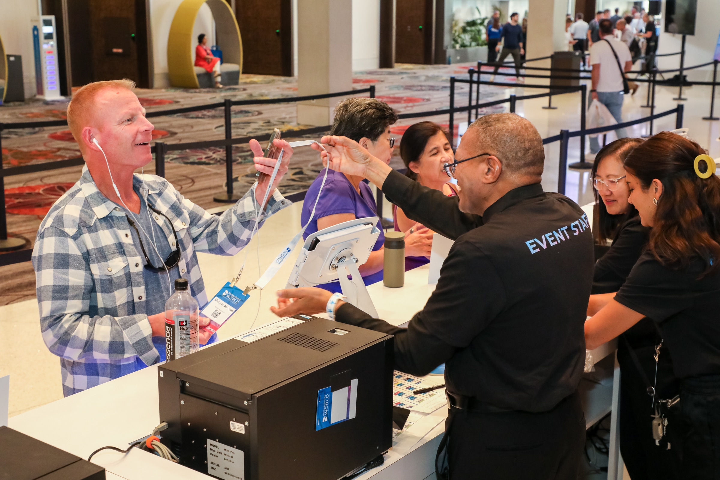 Attendees registering and receiving badge at event check-in