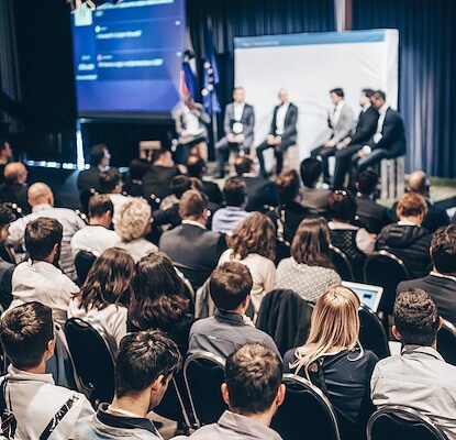 Audience attending a breakout session with speakers leading a discussion on stage, Sea Girt, New Jersey