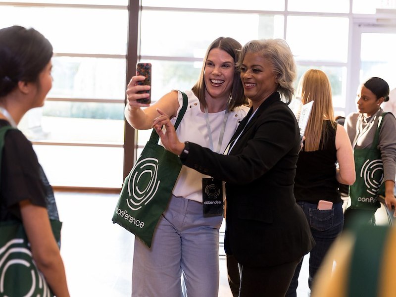 Conference Attendee Taking a Selfie with a Conference Speaker