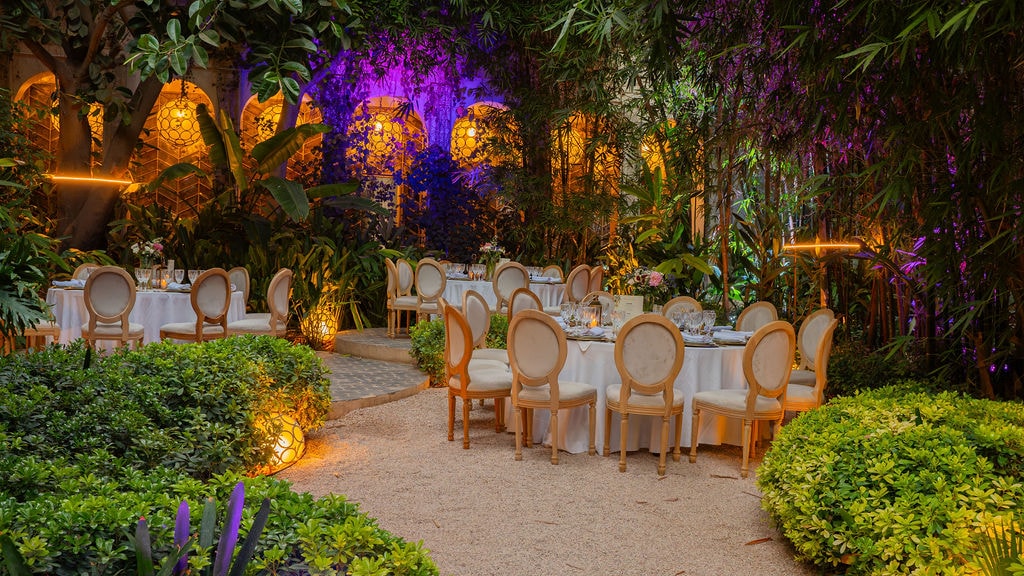 A set up table with chairs and tables in a garden