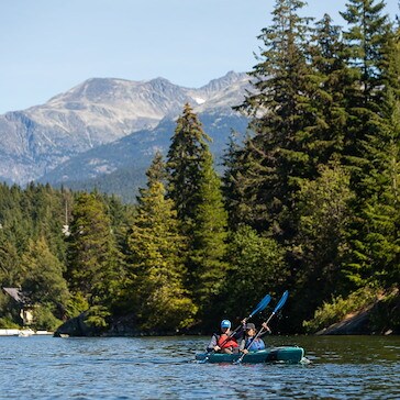 Kayaking on a lake with a mountain backdrop in Whistler, Canada.