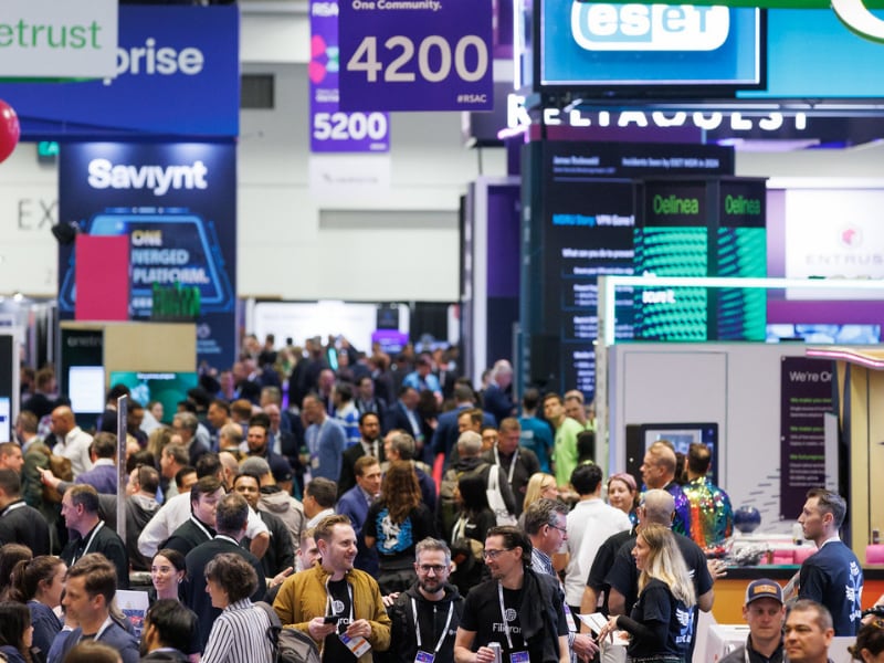 Busy trade show floor with branded booths and attendees