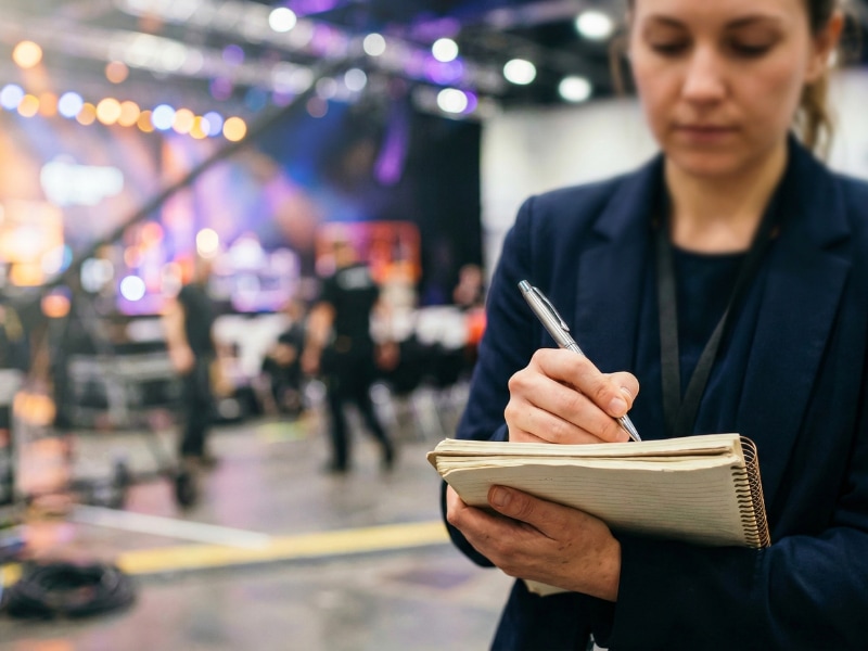 Event planner taking notes backstage