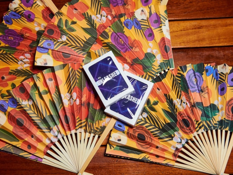 Branded event fans and promotional cards arrangement