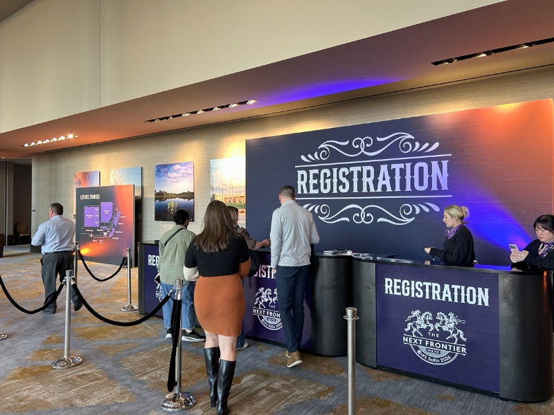 People standing in line at a registration desk