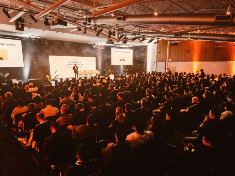 Audience attending a large conference keynote session