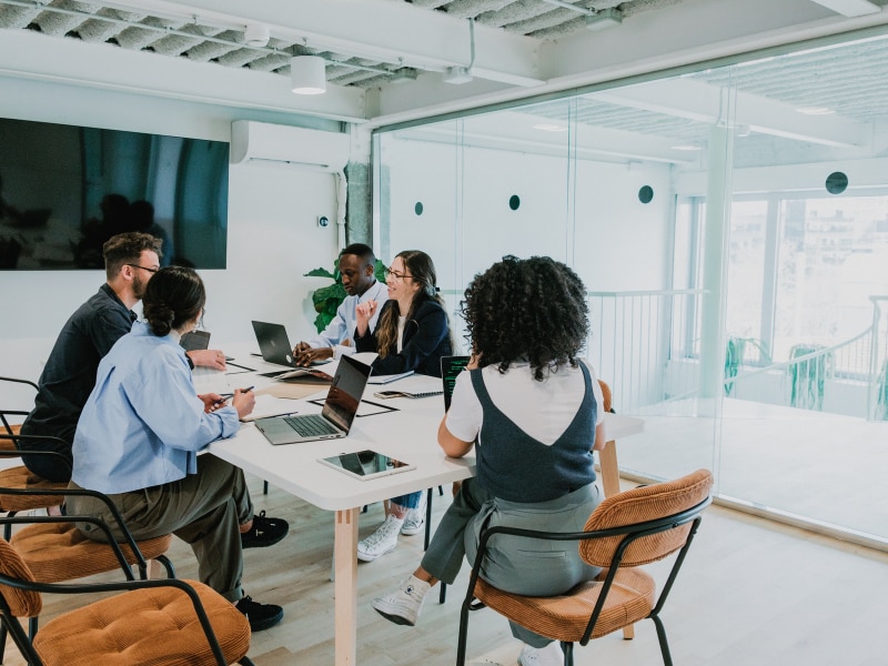 Team gathered in a modern conference room during a leadership retreat