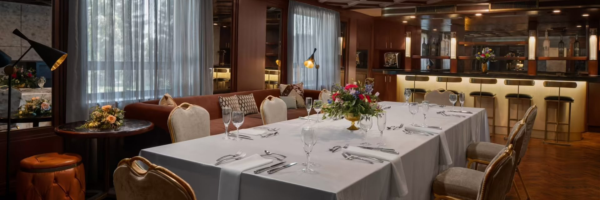 A dining room with a long table and chairs