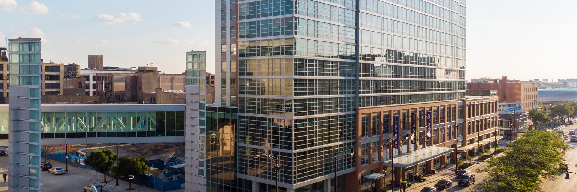 A tall building with a lot of windows on the side of the street