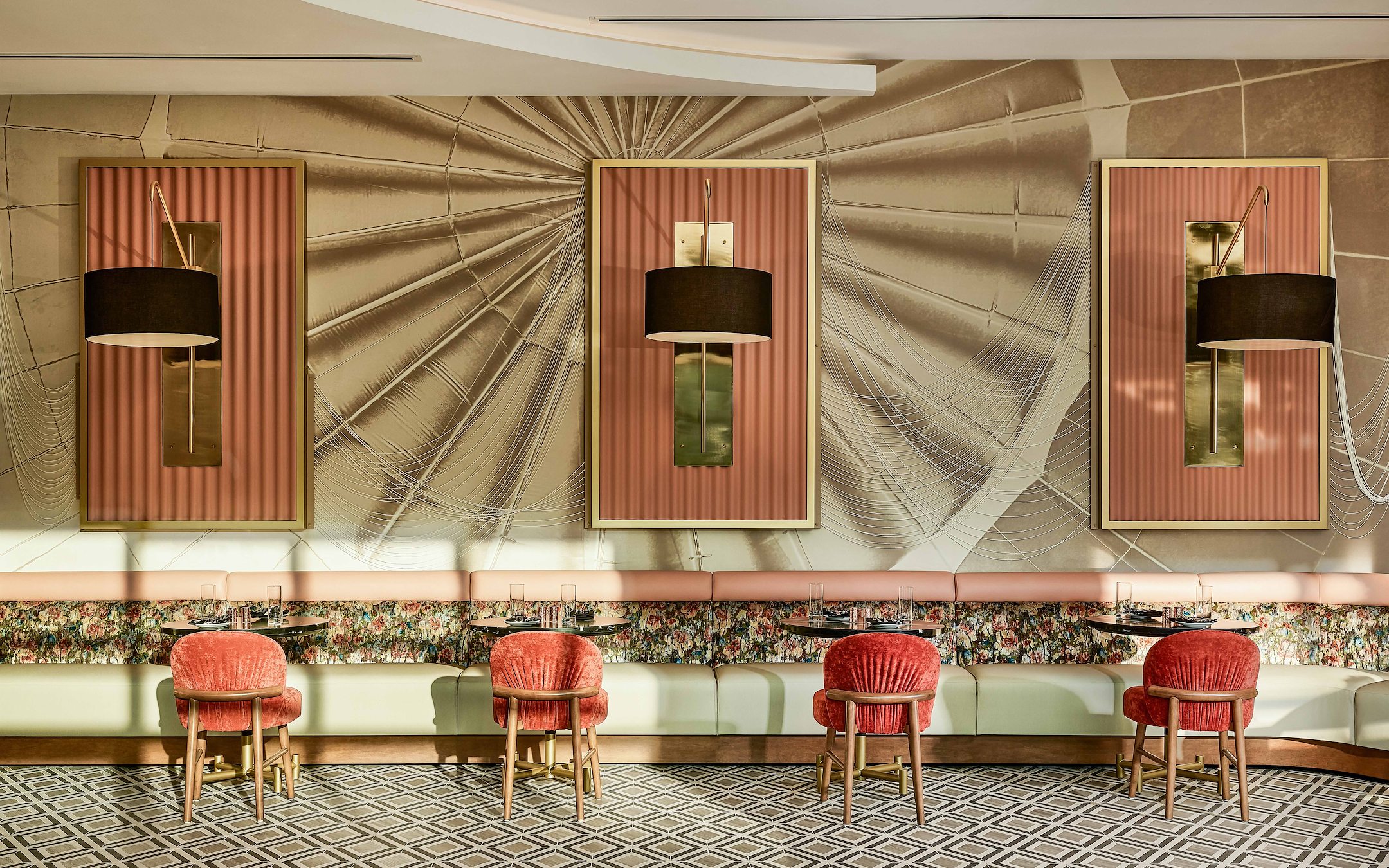 Modern hospitality lounge with large windows, teal seating, bar, wavy lights, checkered floor at first hospitality