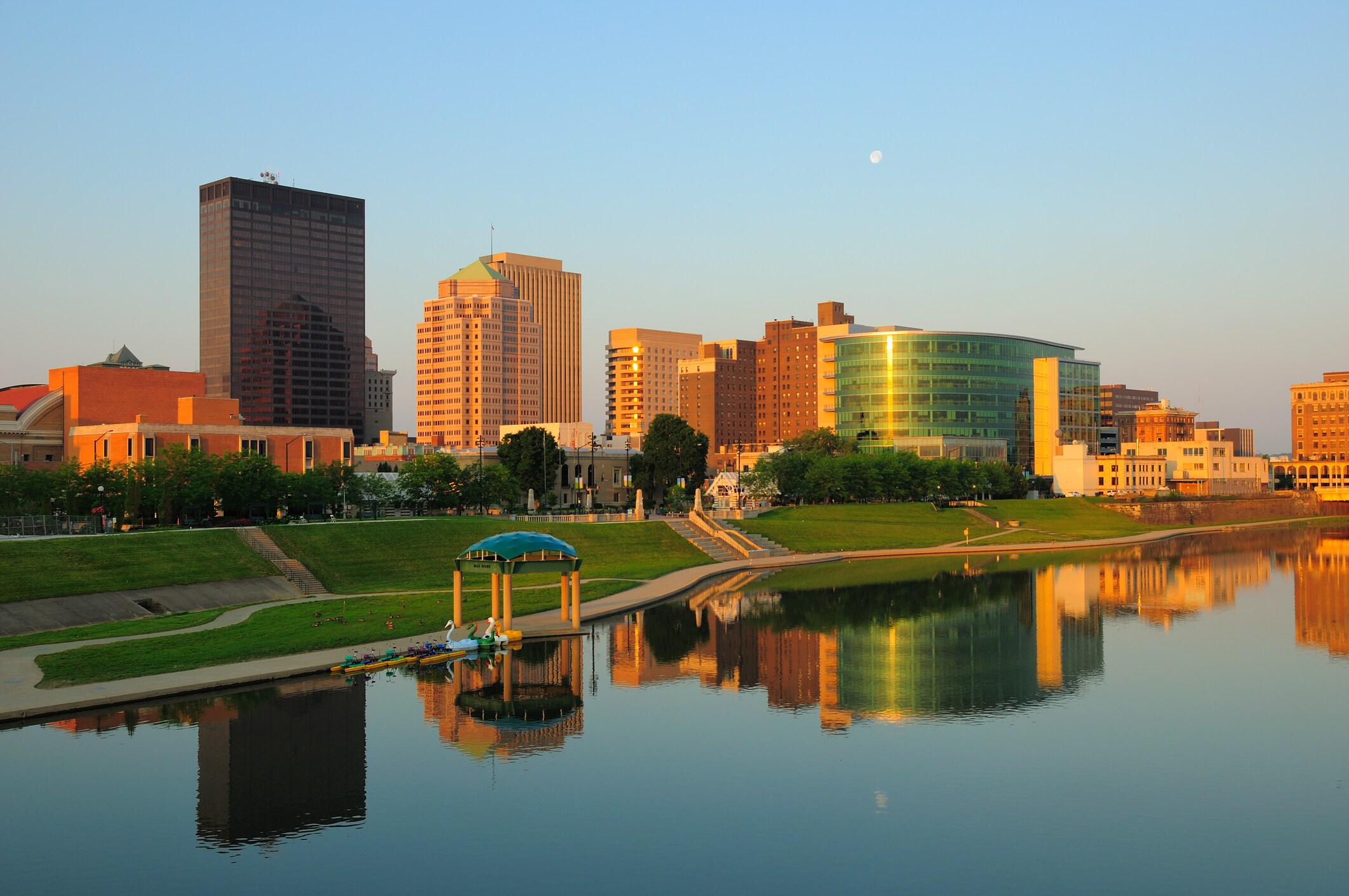 Skyline of Dayton, OH reflected in the river at sunset.