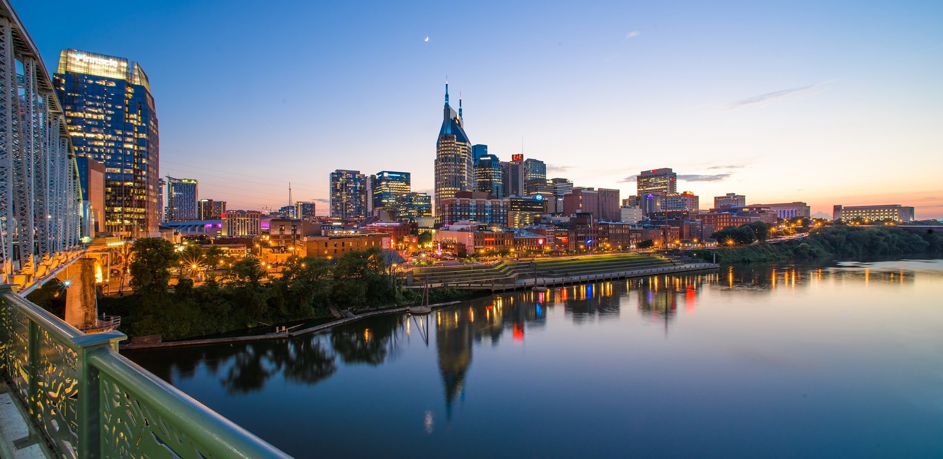 A woman playing guitar in front of a bar