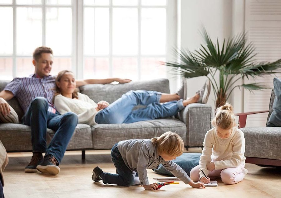 Content parents watching children happily playing