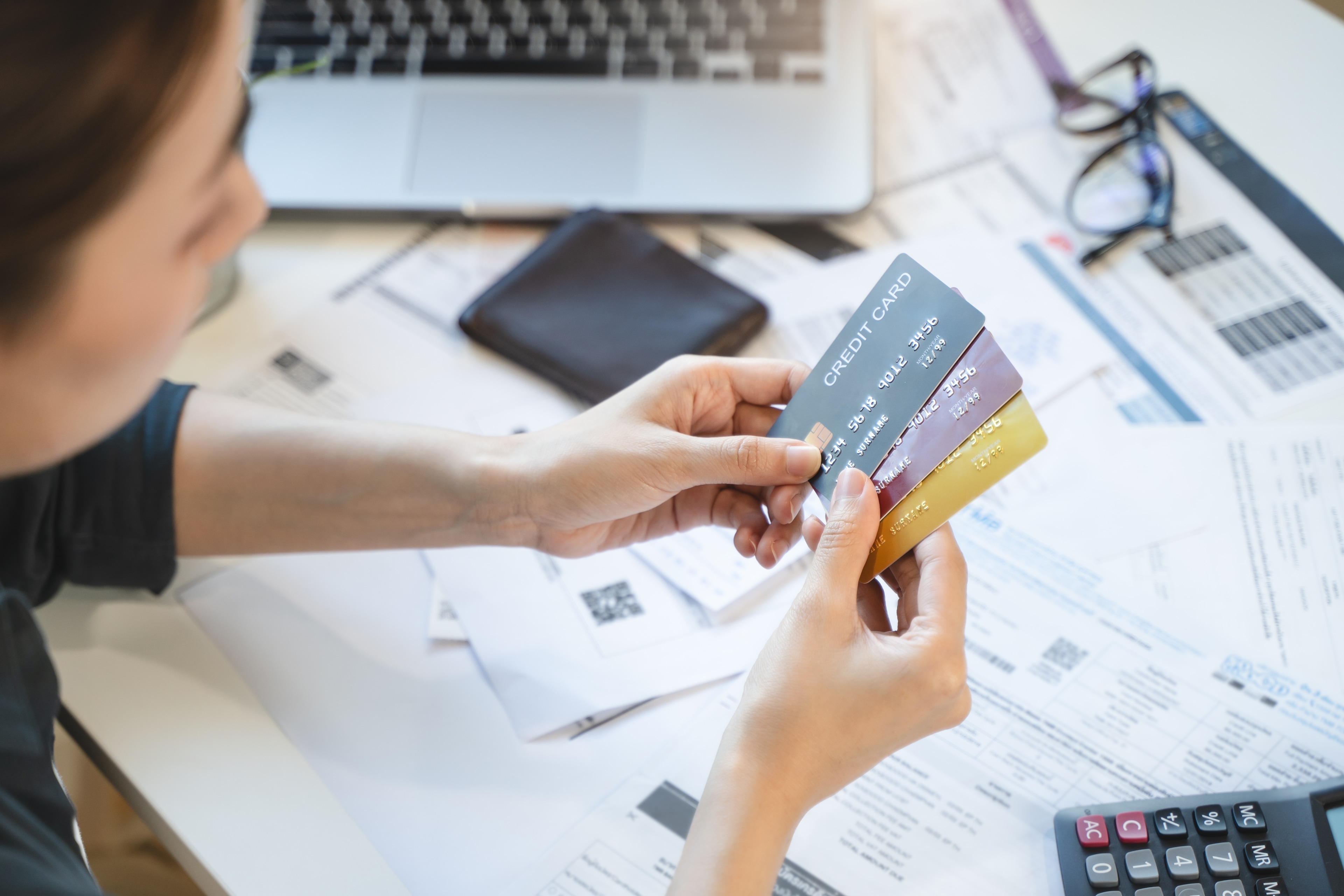 woman reviewing credit card bills and consolidating her debt