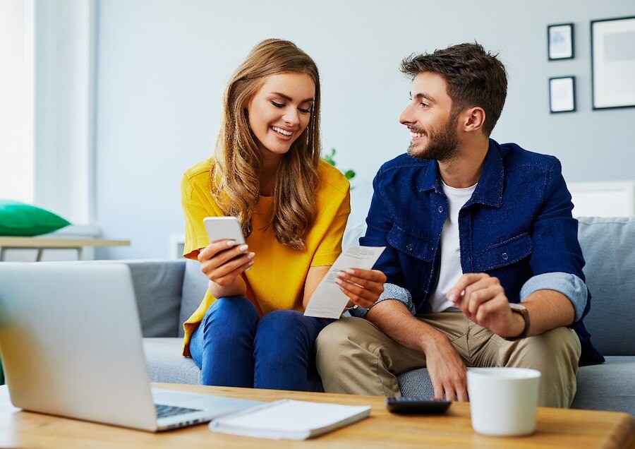 Happy couple tracking their spending through FCU Anywhere.