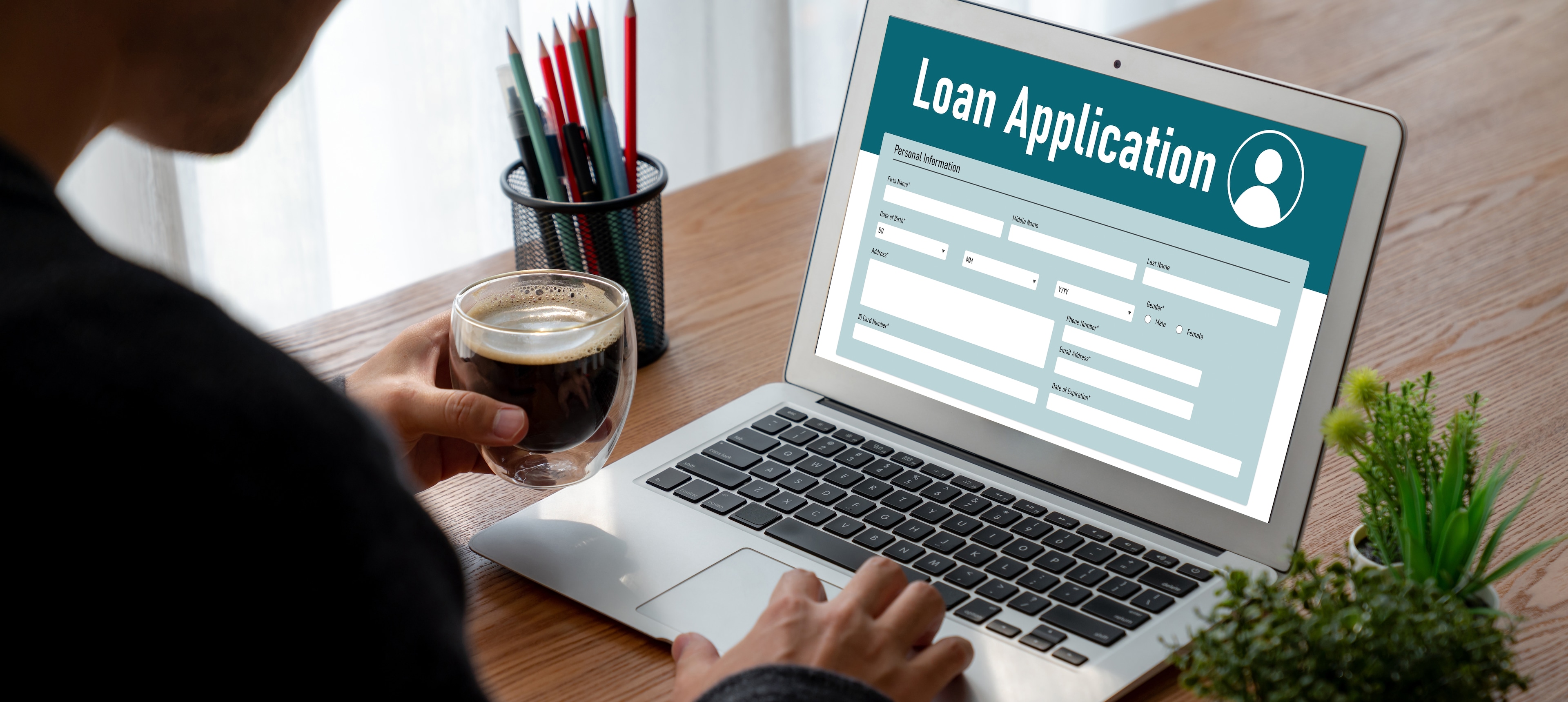 person filling out personal loan application on a laptop