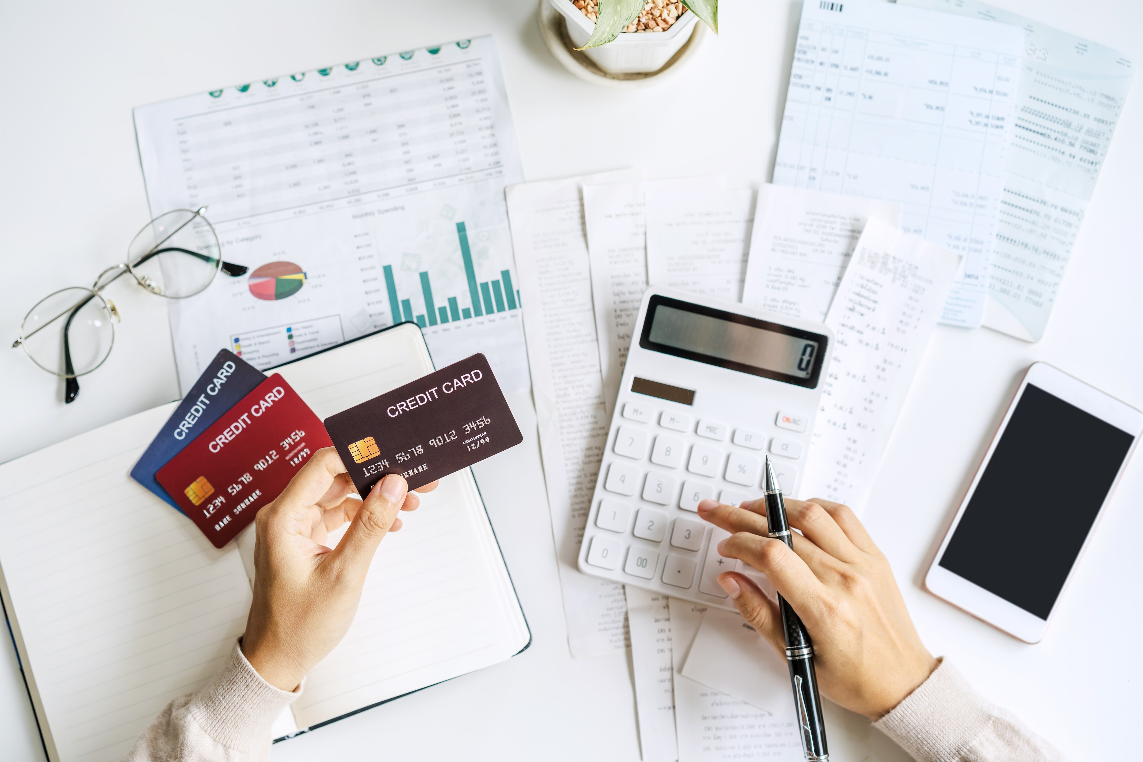 Person calculating credit card payments to pay down
