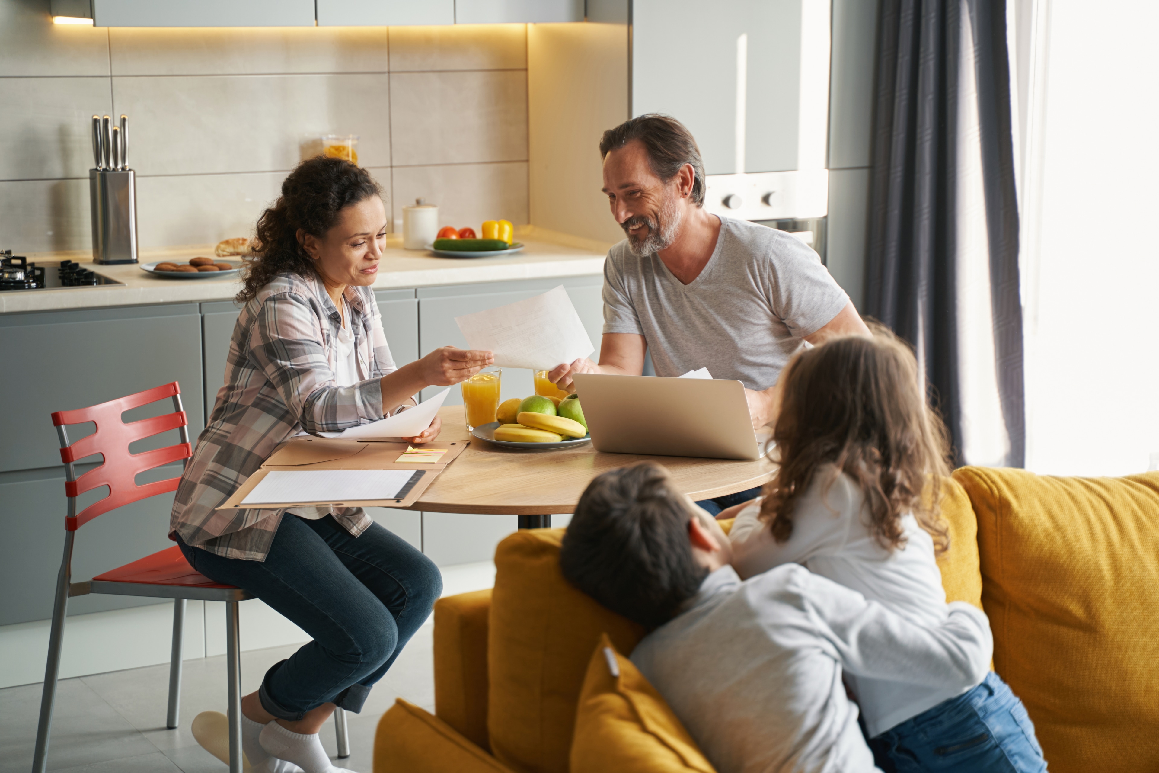 Family reviews tax deduction options around kitchen table.
