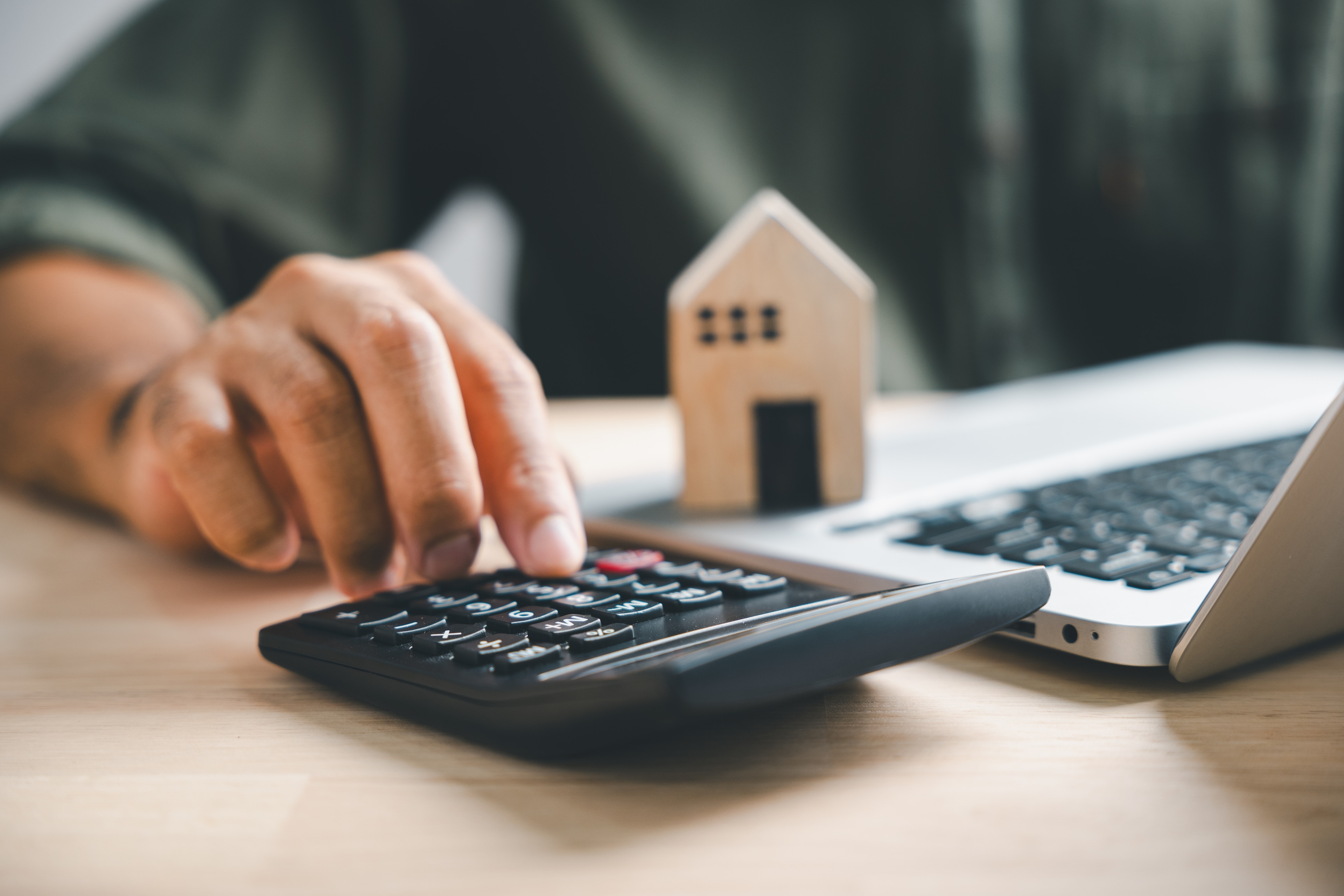 Person calculating mortgage refinance.