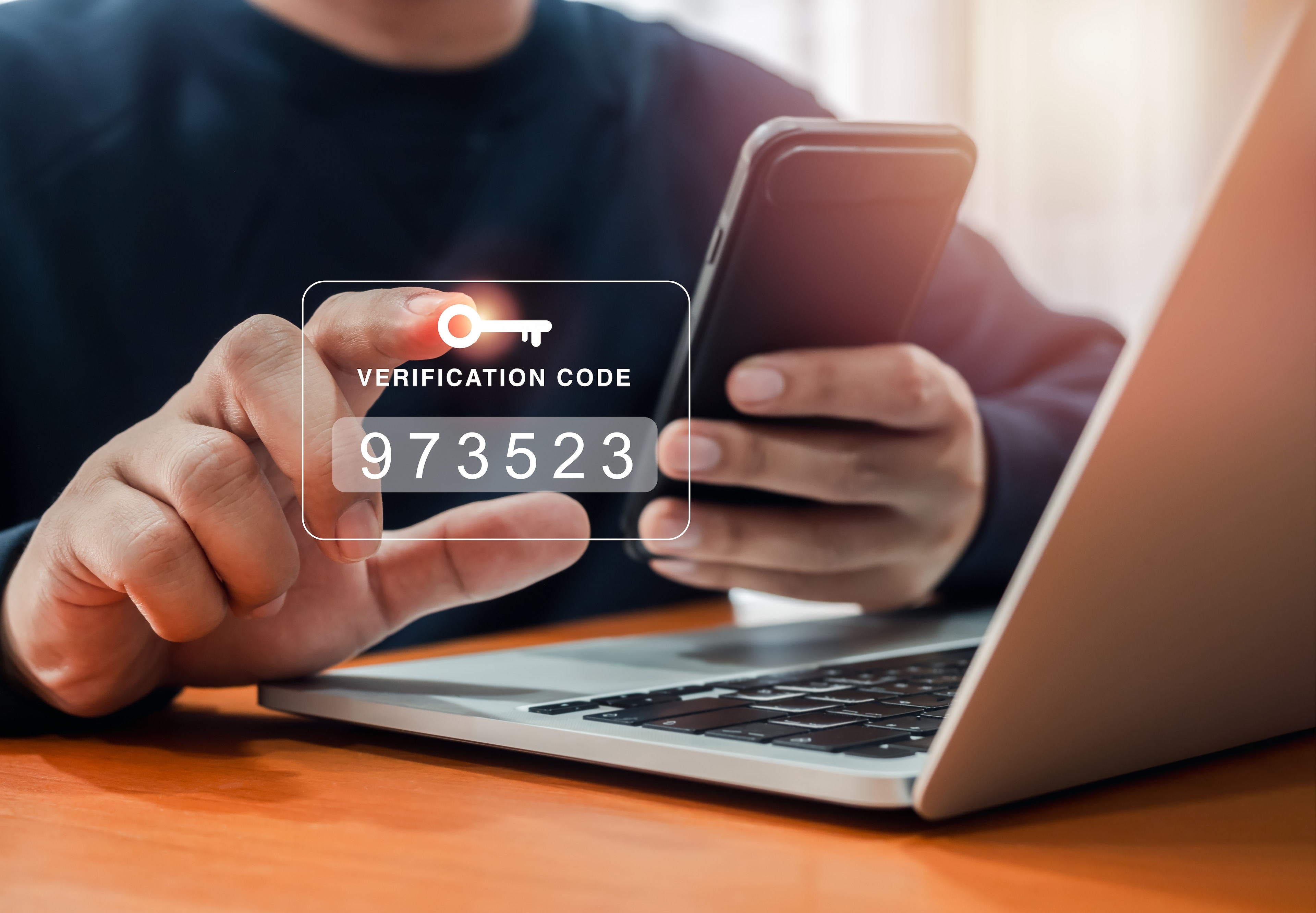 Person receiving a verification code on their mobile phone.