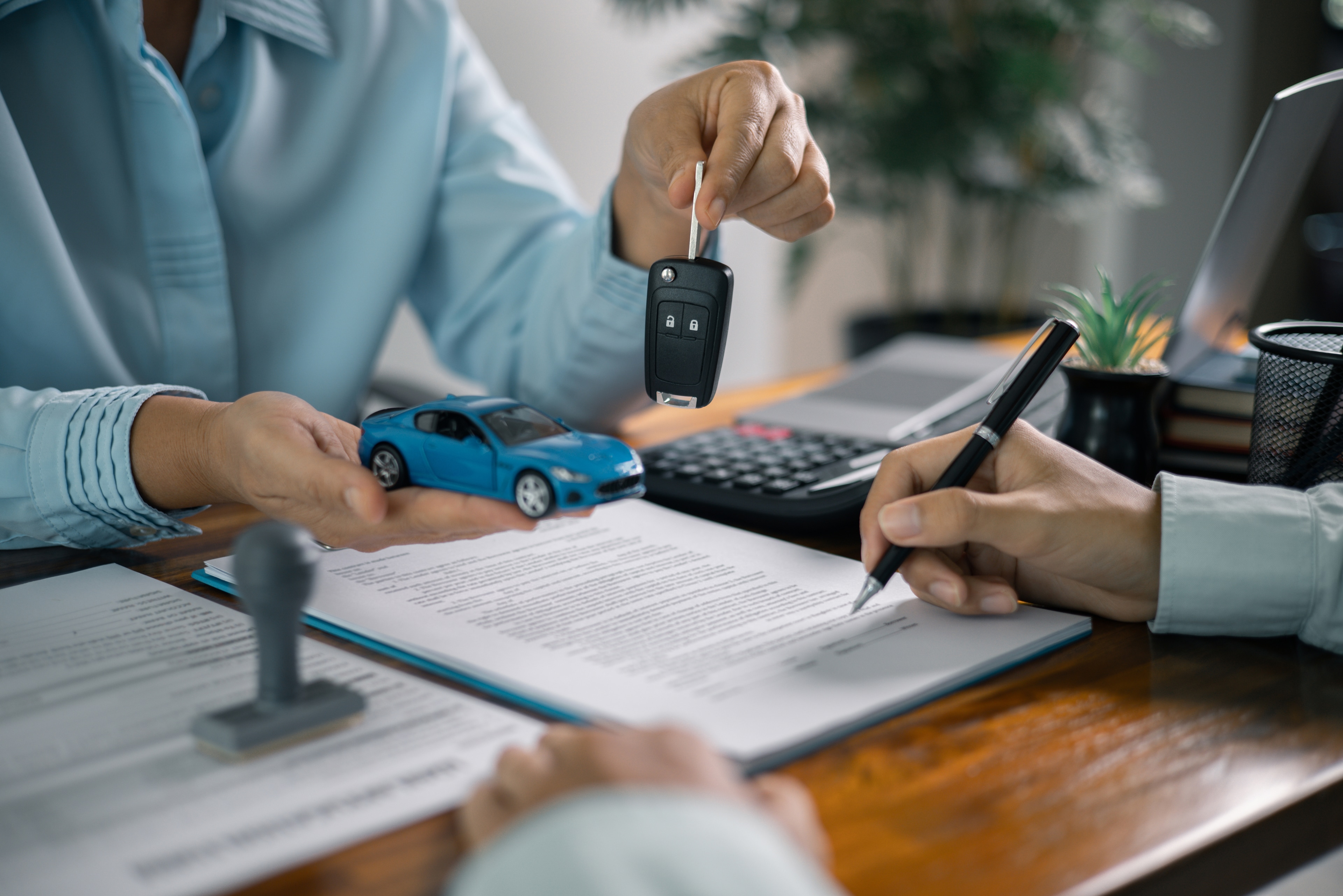 First time car buyer signing and receiving keys.