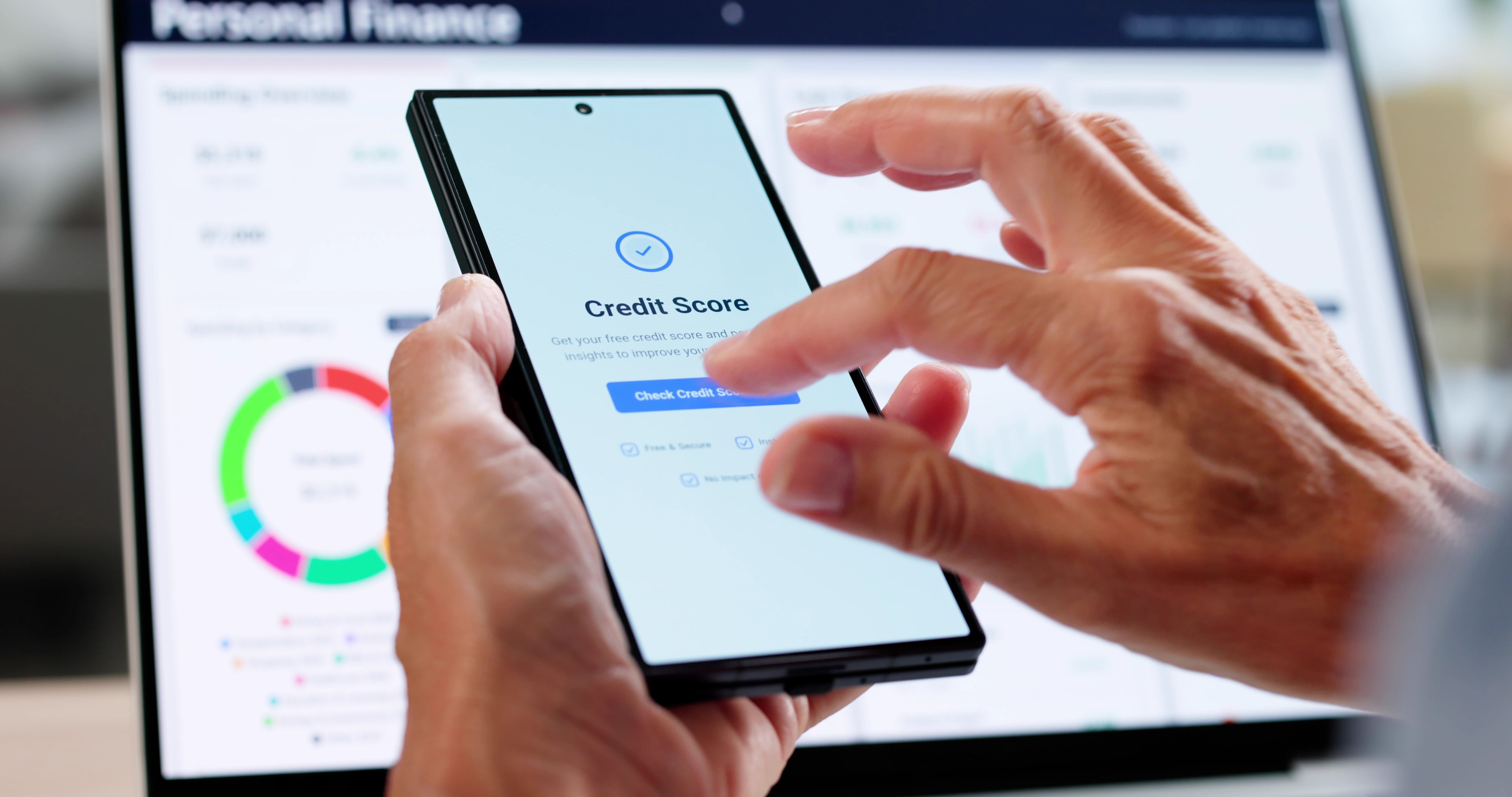 Person checking their credit score on their phone for an auto loan.