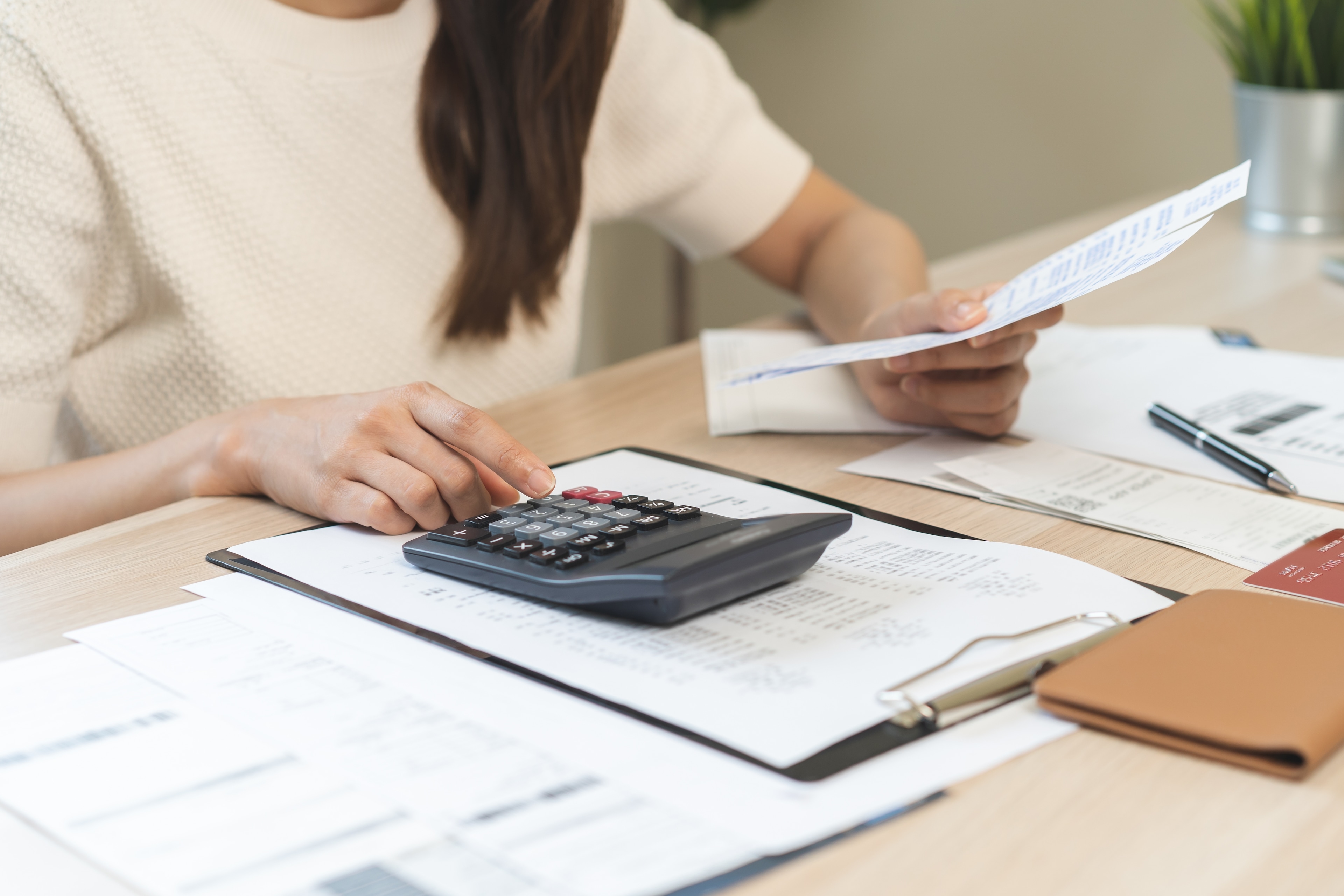 Young woman calculating personal loan options.