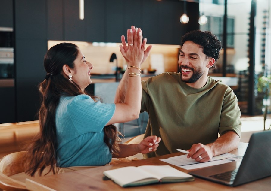 Happy couple approved for a debt consolidation loan.
