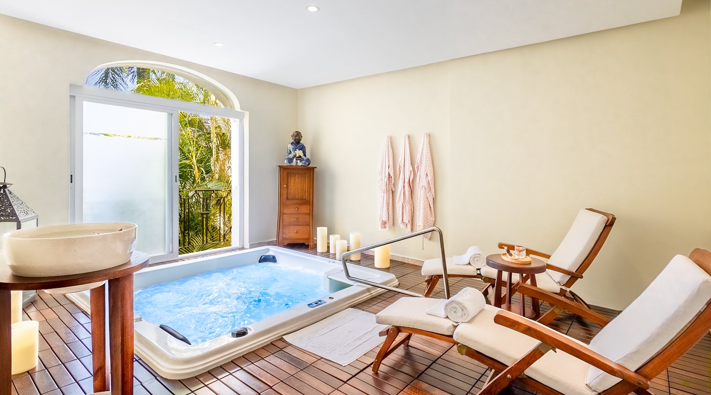 A spa room with a jacuzzi tub and a table, Casa Velas, Puerto Vallarta, Mexico