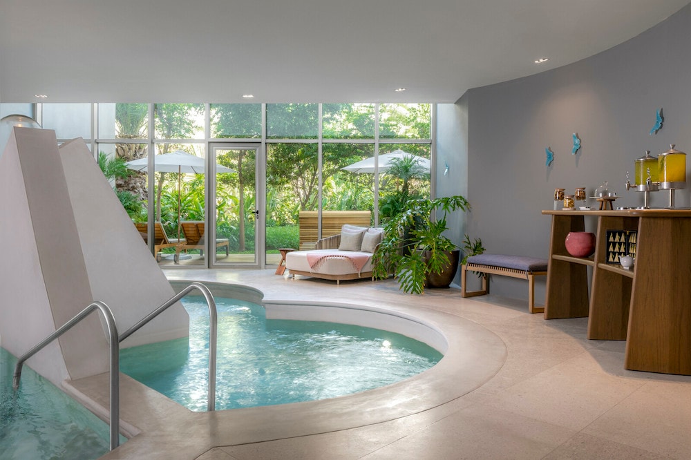 A indoor pool with a hot tub and a couch