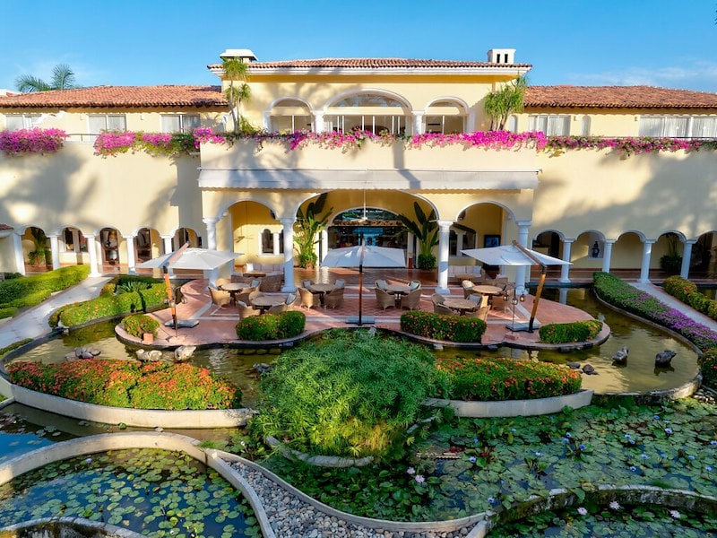A building with a pond and water garden
