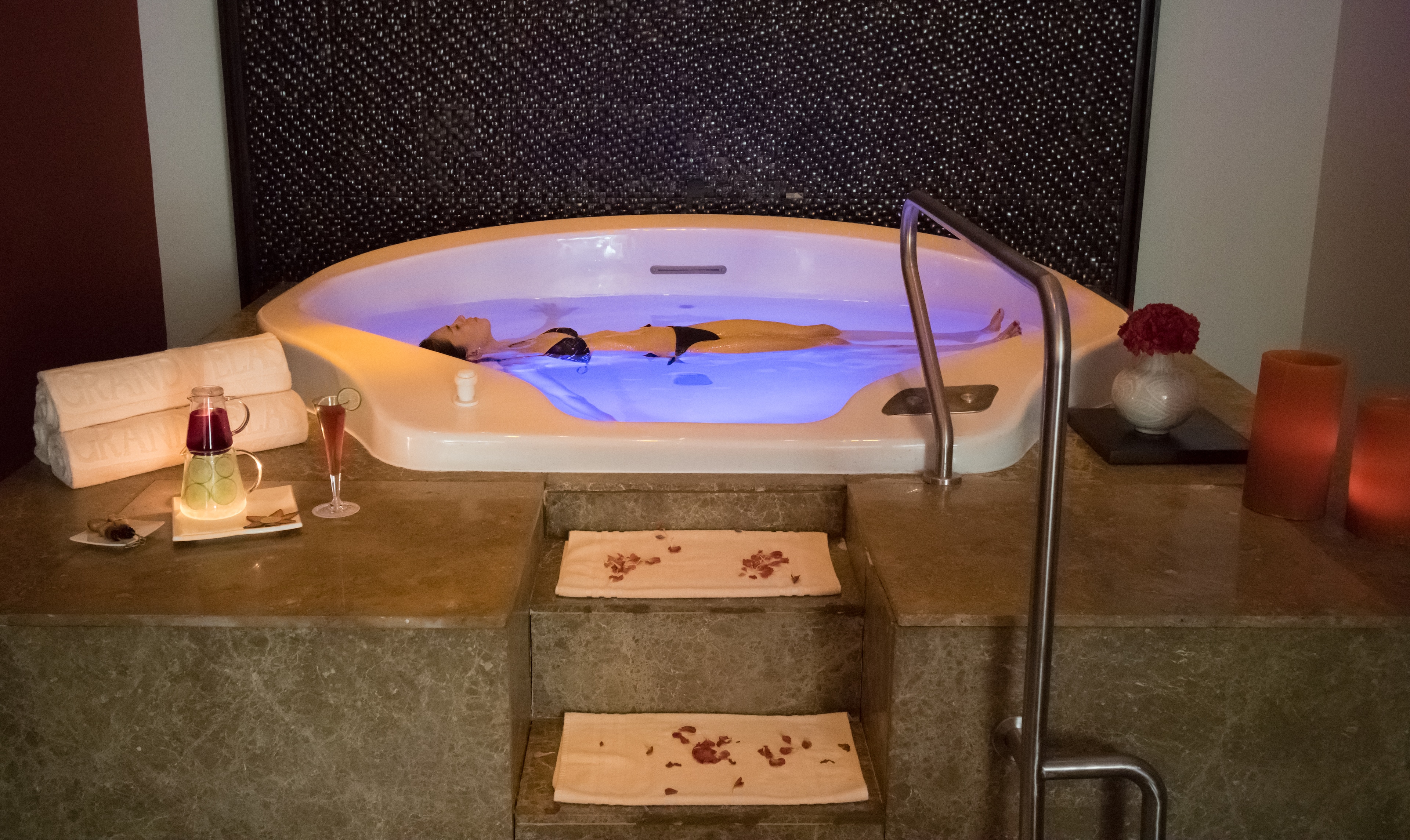 A woman in a hot tub enjoying wellness experiences