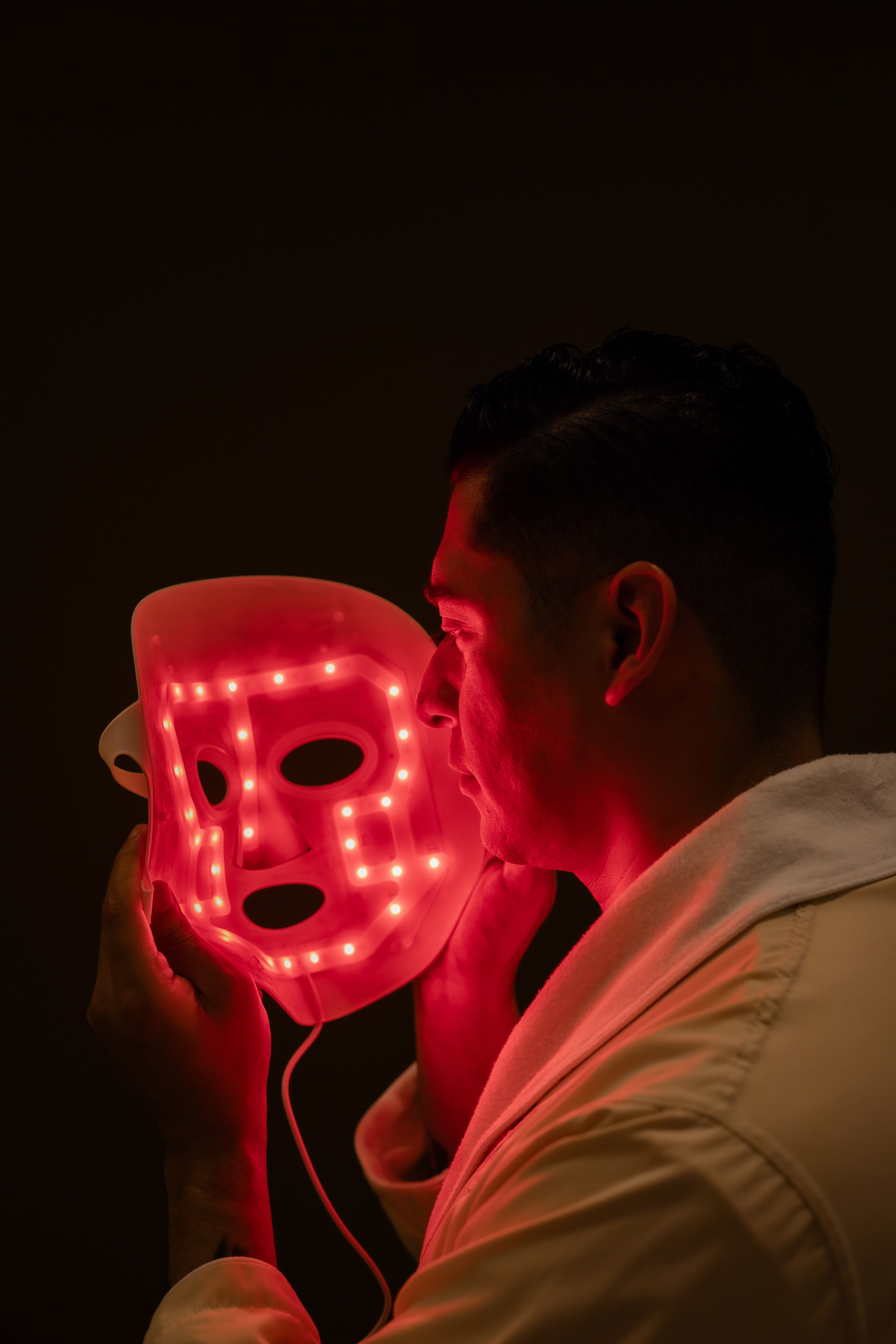 A man holding a LED mask