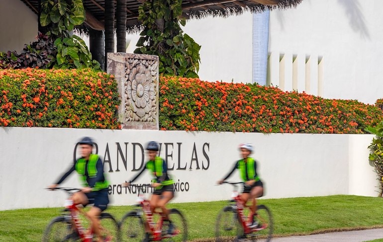 A group of people riding bicycles on a road