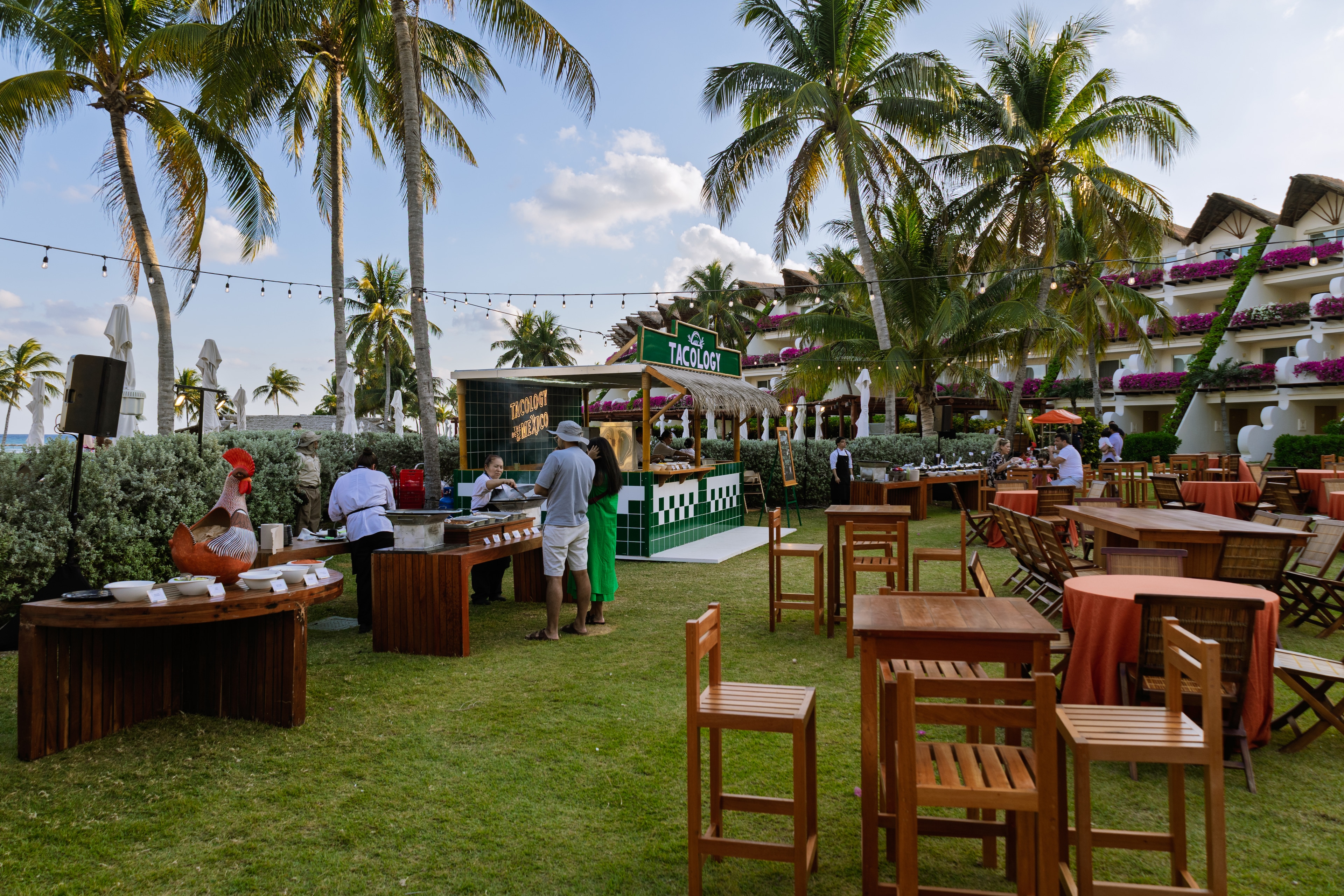 A group of people outside with tables and chairs