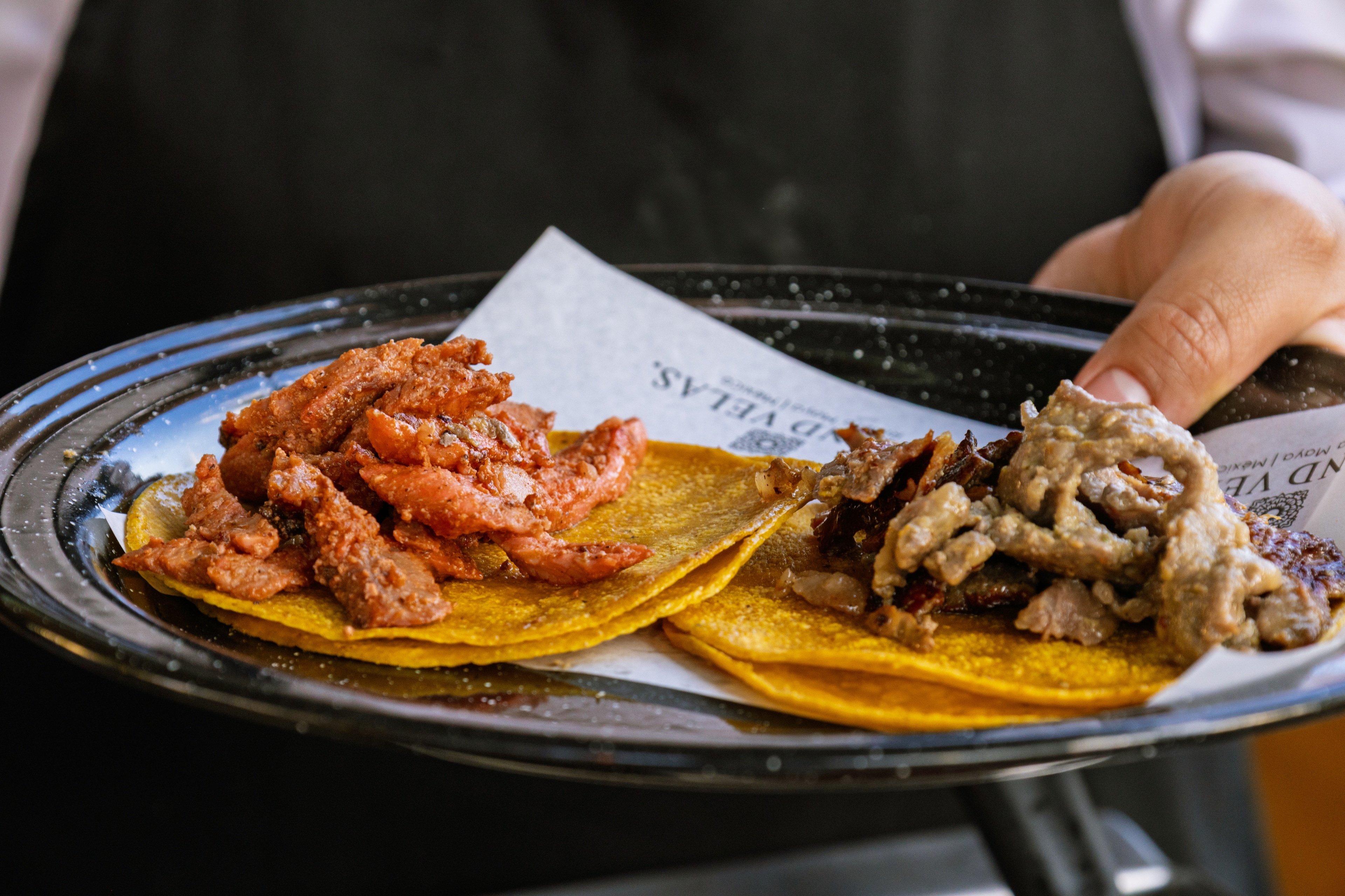 A plate of tacos with meat and sauce