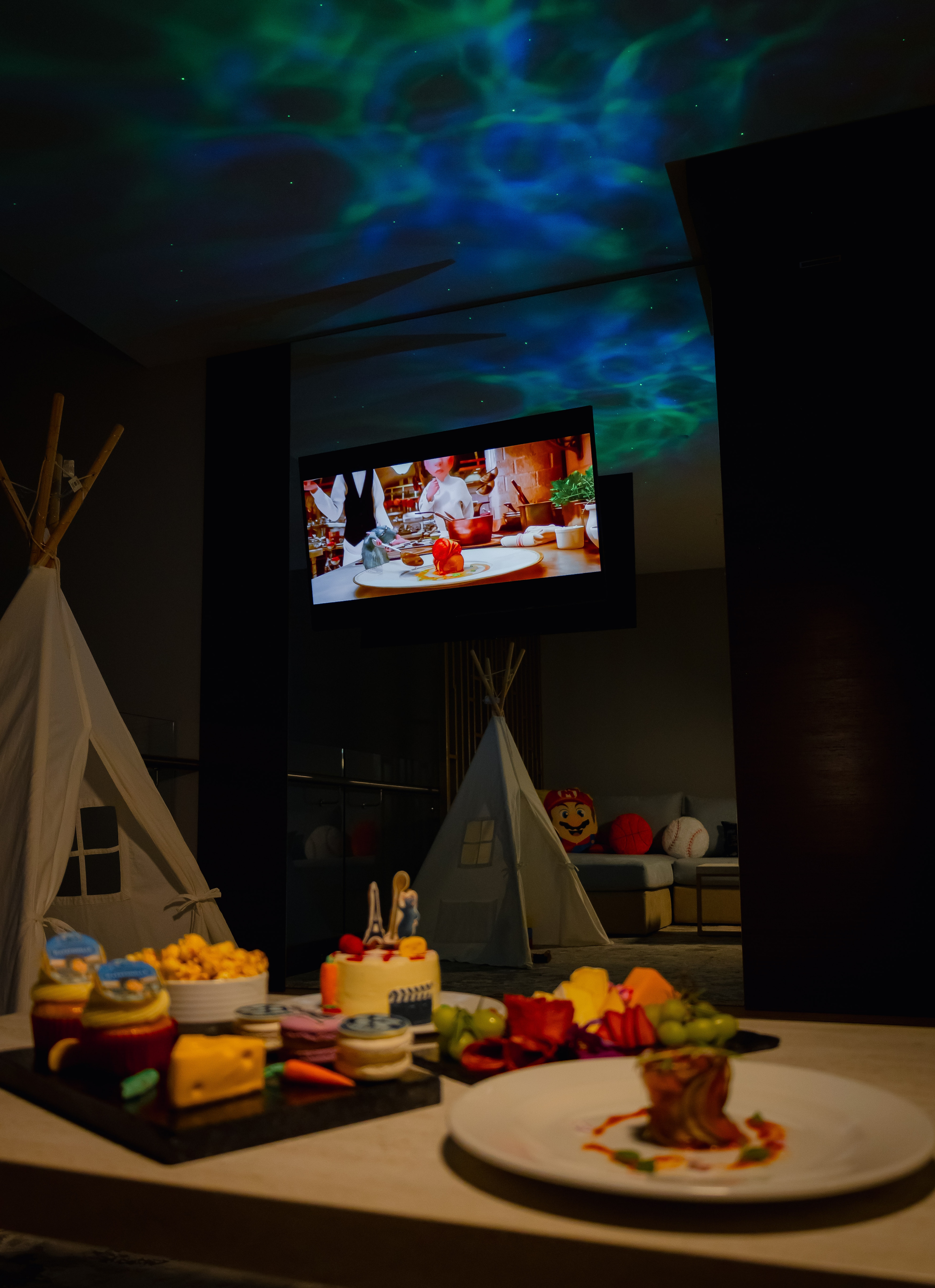 A table with food on it and a television in the background