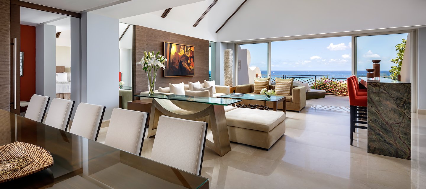 A living room with a dining table and a view of the ocean, Grand Velas Riviera Maya, Playa del Carmen, Mexico