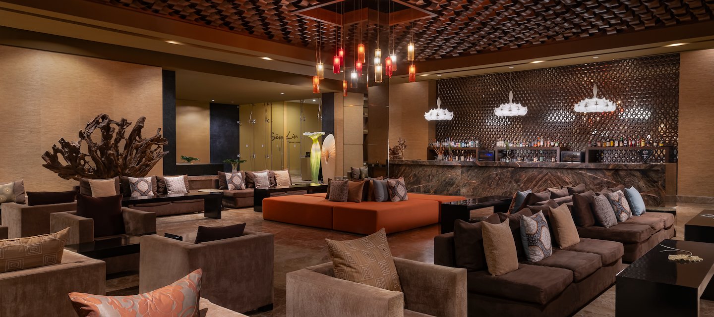 The lobby of a hotel with a bar and seating, Grand Velas Riviera Maya, Playa del Carmen, Mexico