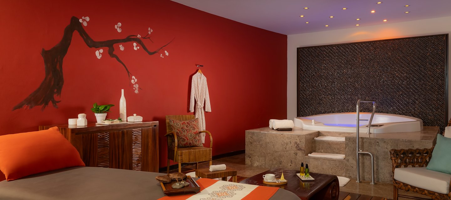 A spa room with a jacuzzi tub and a table, Grand Velas Riviera Maya, Playa del Carmen, Mexico