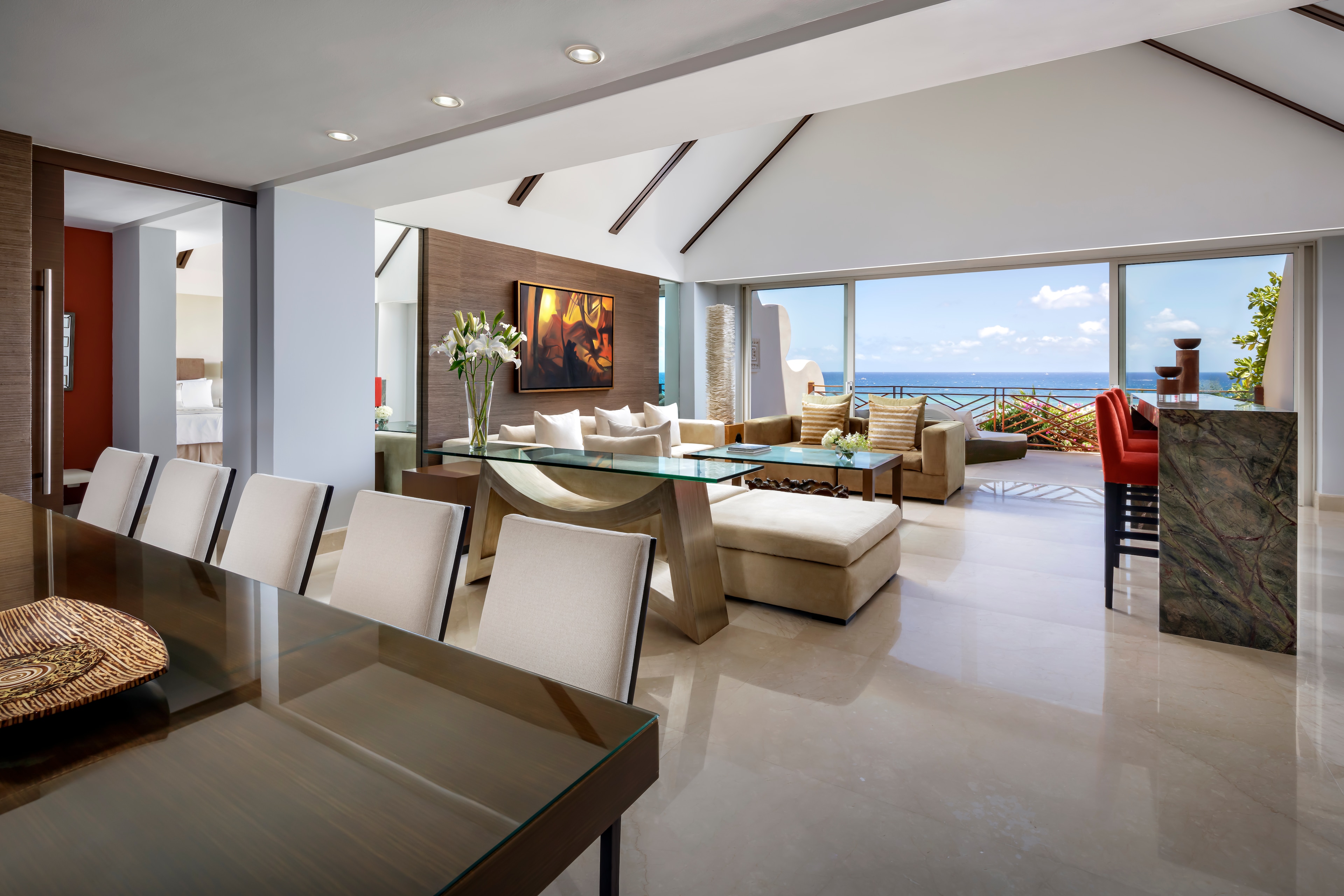 A living room with a dining table and a view of the ocean, Grand Velas Riviera Maya, Playa del Carmen, Mexico