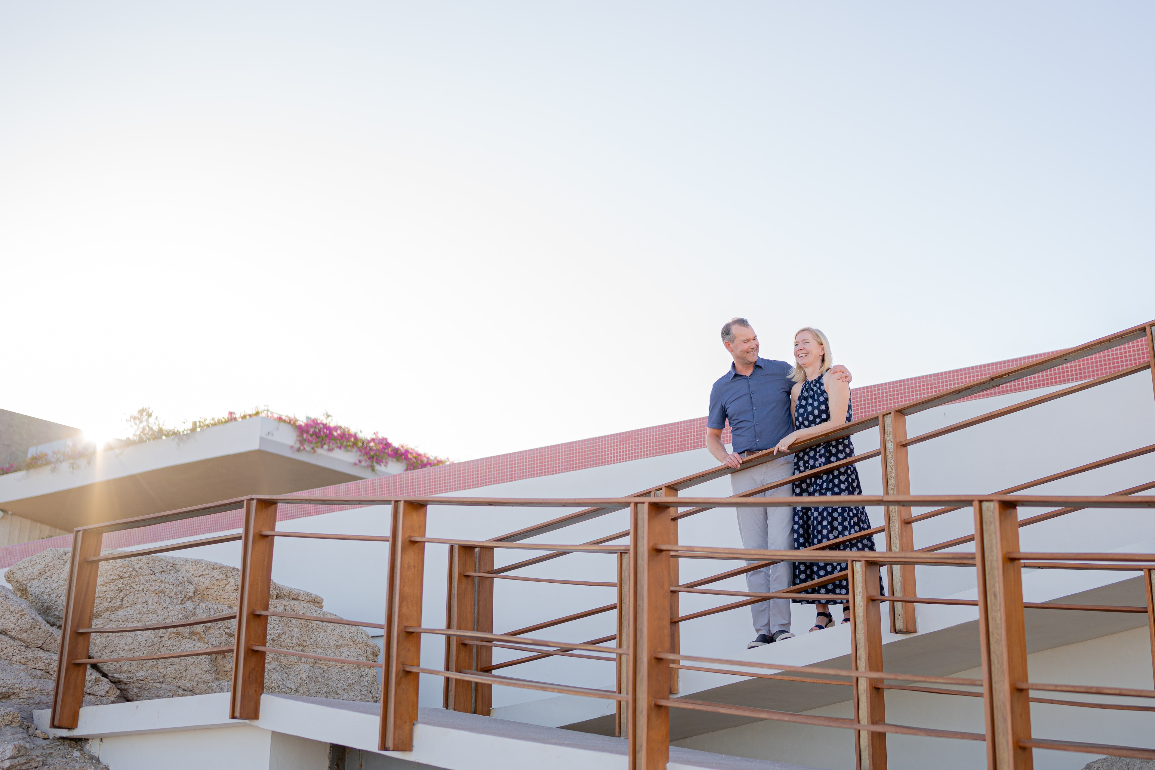 A man and woman standing on a railing