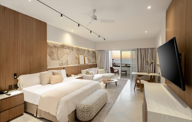 A room with a bed and a television