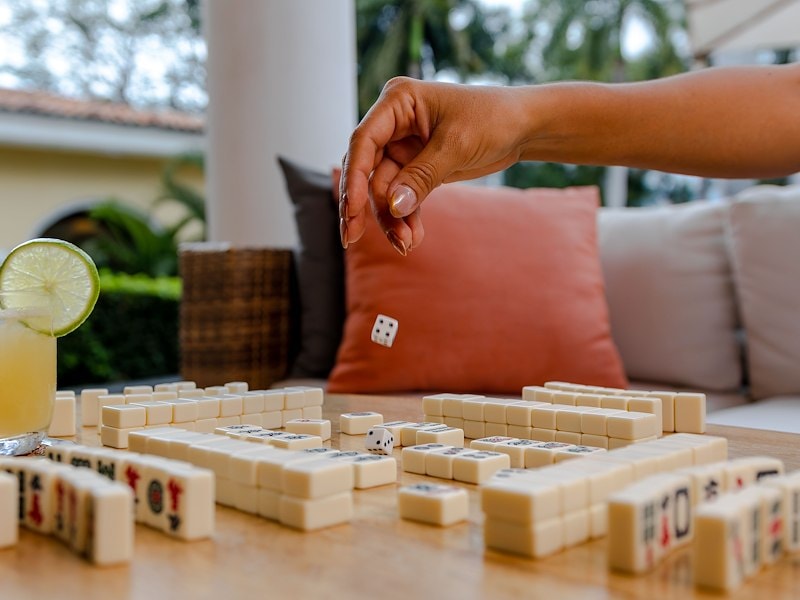 A hand throwing a dice into a game