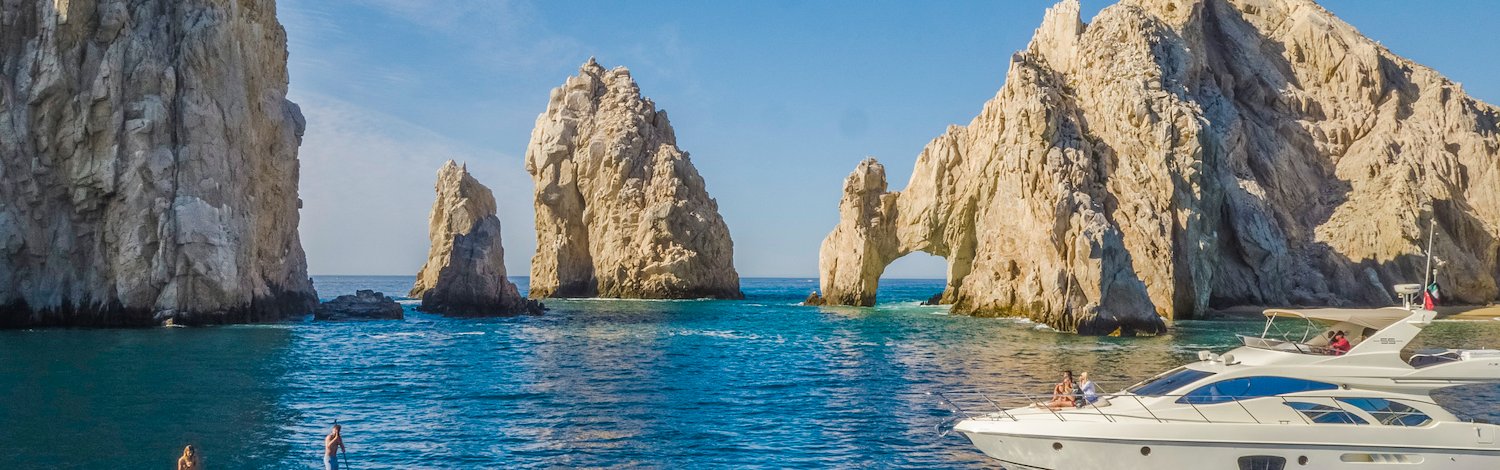 A boat is in the water near some rocks, Grand Velas Los Cabos, San Lucas, Mexico
