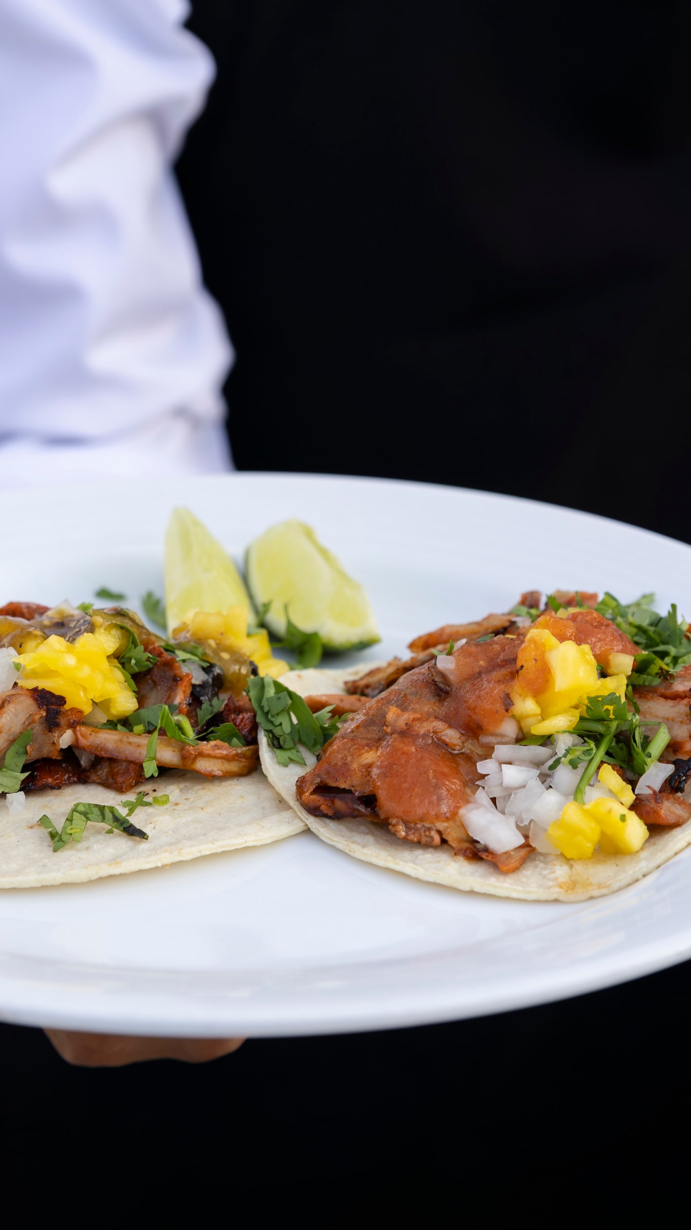 A plate of tacos with meat and vegetables