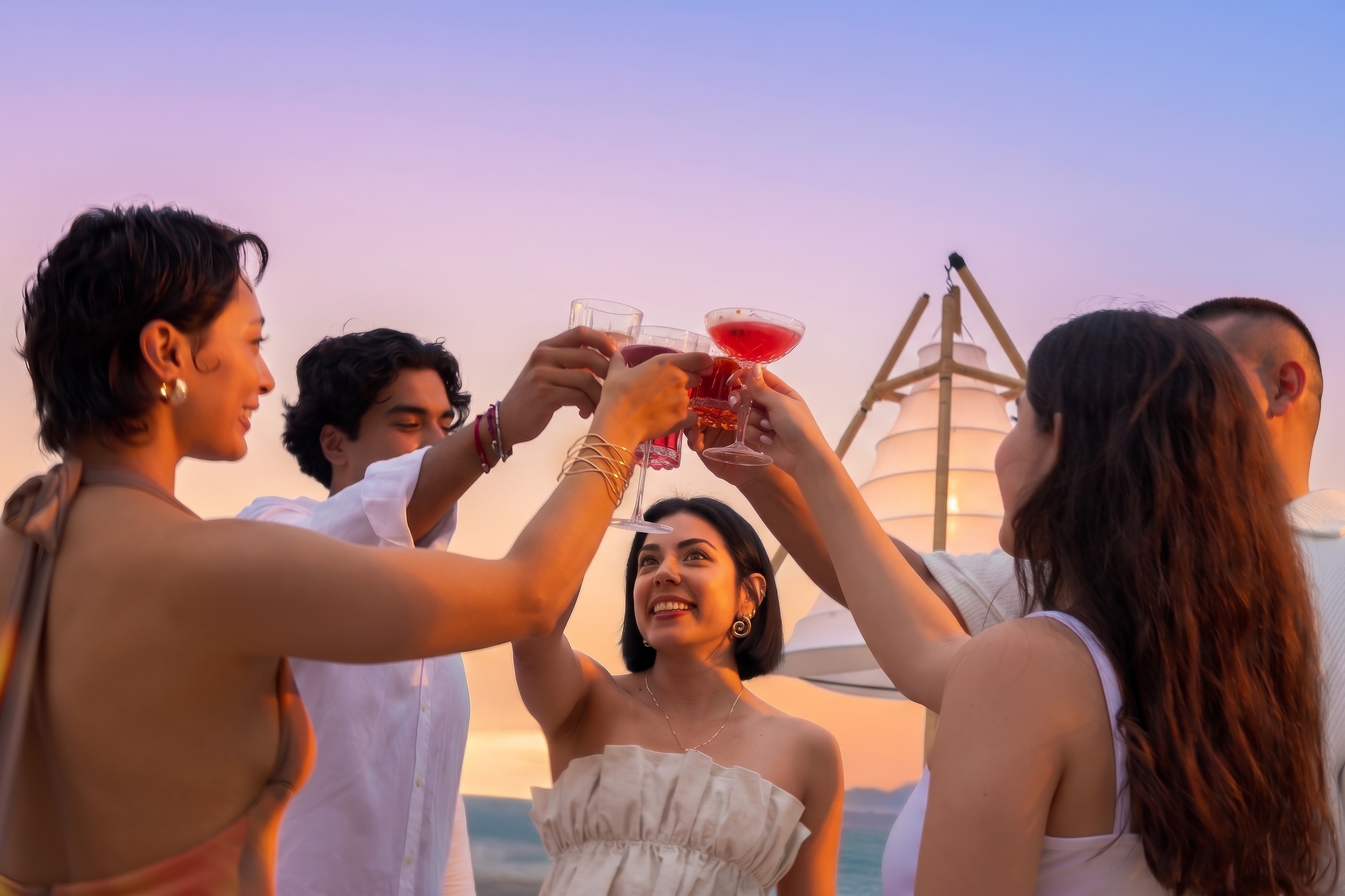 a group of people holding cups in the air