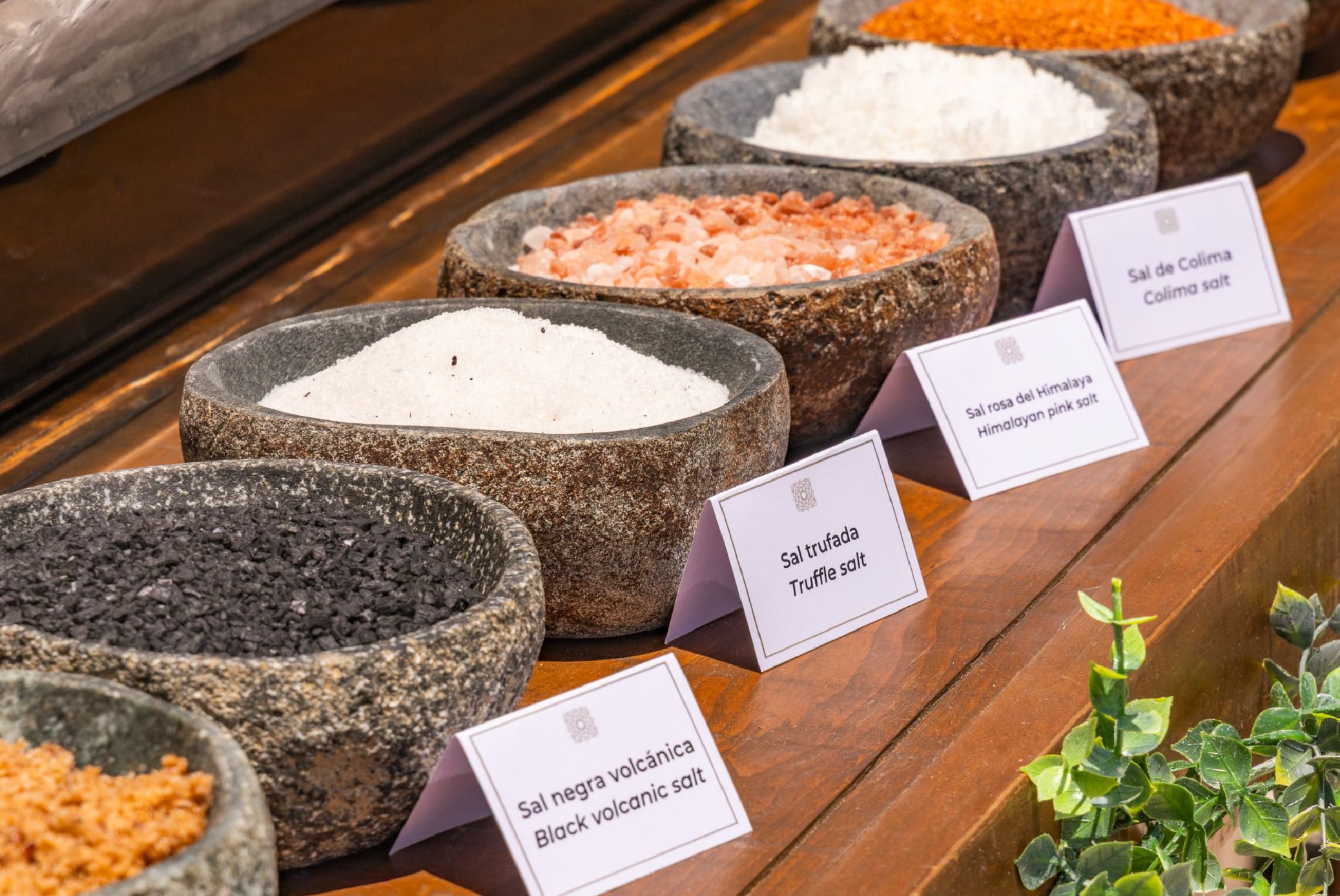 A group of bowls of salt and other spices